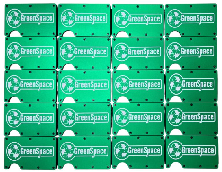 GreenSpace logo laser engraved on a set of bright green metal wallets