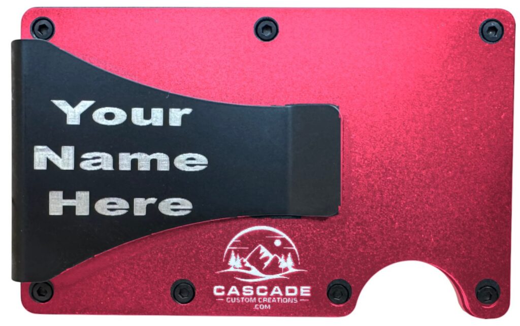Back of a red metal wallet showing a name laser engraved on the cash clip