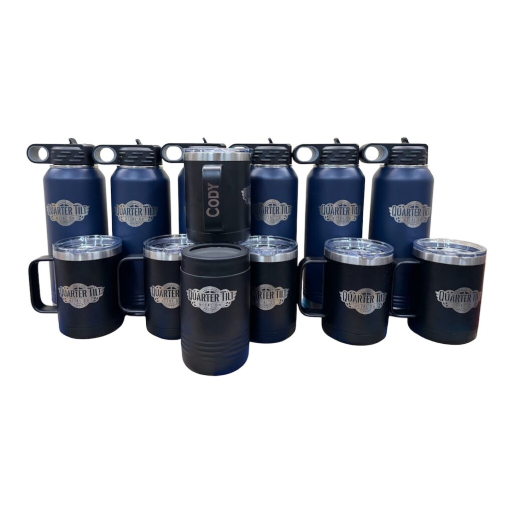 Quarter Tilt company logo laser engraved on navy water bottles, mugs and can holders