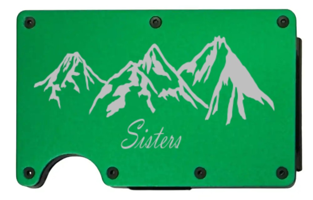 Sisters Mountains design laser engraved on a bright green metal wallet (preview)