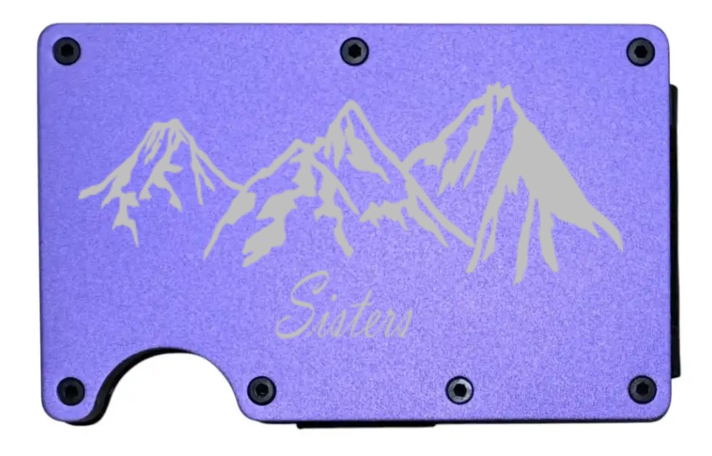 Sisters Mountains design laser engraved on a purple metal wallet (preview)
