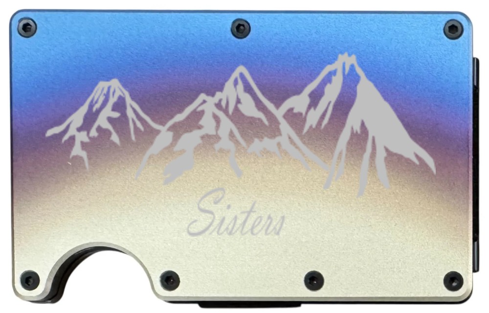 Sisters Mountains laser engraved on a titanium finish metal wallet