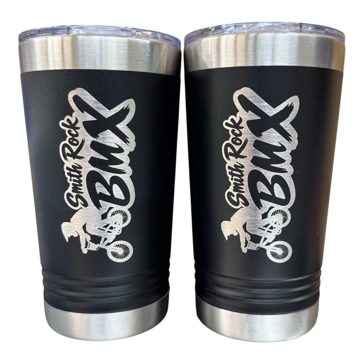 Smith Rock BMX logo with a BMX rider laser engraved on two black tumblers